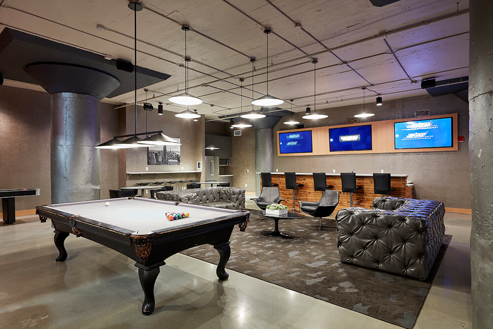 pool table, couches, bar and tv screens in clubroom